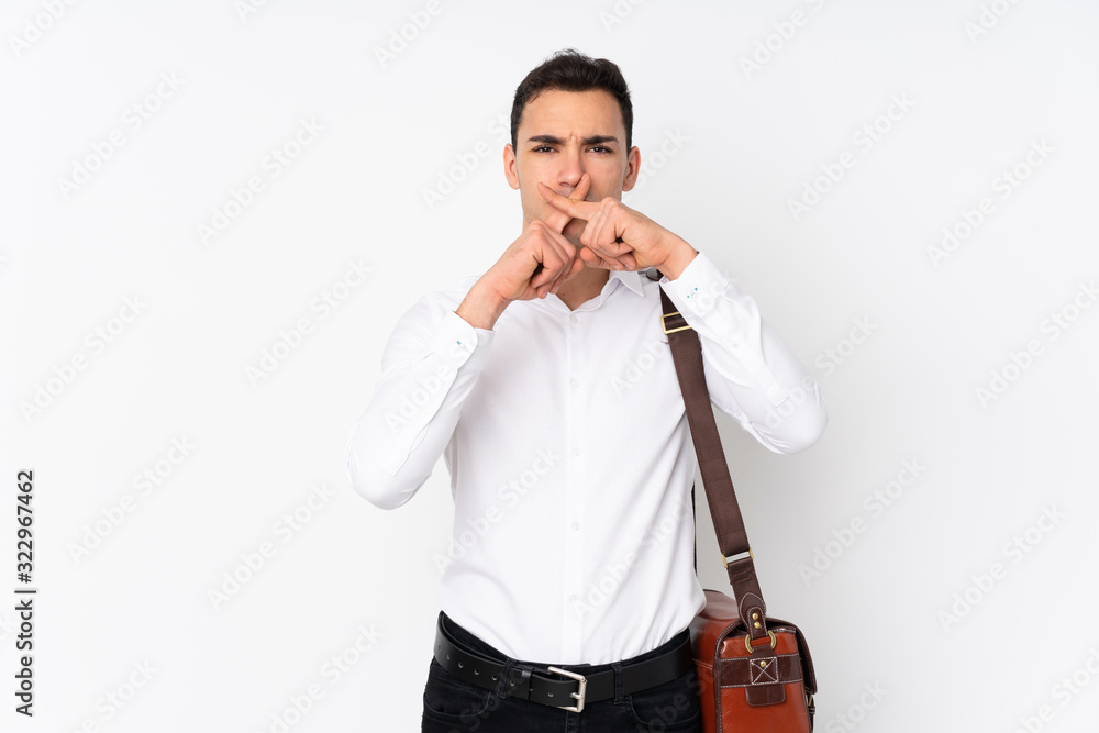 Young handsome businessman on isolated background showing a sign of silence gesture Young handsome businessman on isolated background showing a sign of silence gesture