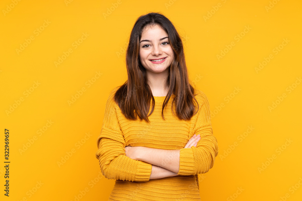 Young caucasian woman isolated on yellow background with arms crossed and looking forward Young caucasian woman isolated on yellow background with arms crossed and looking forward