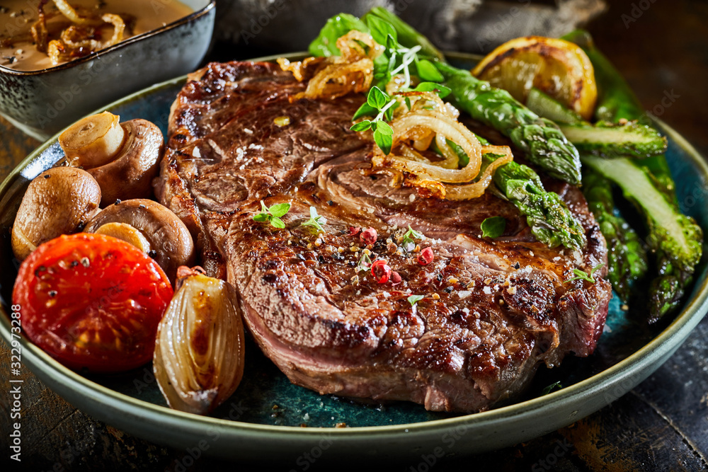 Large portion of grilled beef steak with asparagus Large portion of grilled beef steak with asparagus