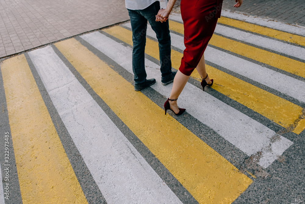 Couple crossing road on way . Zebra traffic walk way in the city. Concept pedestrians passing a crosswalk.