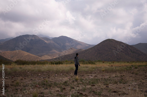 men in the field, view Los andes mountain