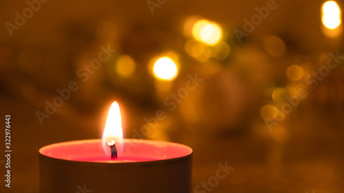 Close up of a red candle at night; an abstract background of candle