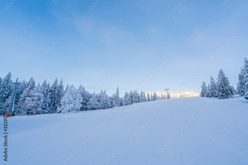 Beautiful snowy ground scenery in winter against sunny weather and blue sky
