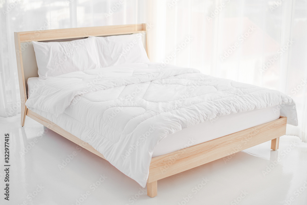 Relaxation concept, interior decoration, comfort and bedding - white bed with white pajamas