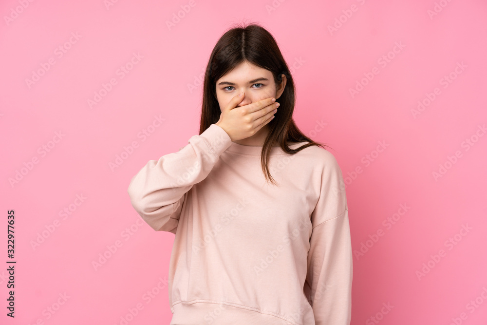 Young Ukrainian teenager girl over isolated pink background covering mouth with hands Young Ukrainian teenager girl over isolated pink background covering mouth with hands