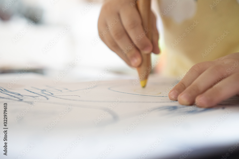 Close up hand of 2year kid use color pencil draw line on paper. Concept of art for children learning . Education and imagination Close up hand of 2year kid use color pencil draw line on paper. Concept of art for children learning . Education and imagination