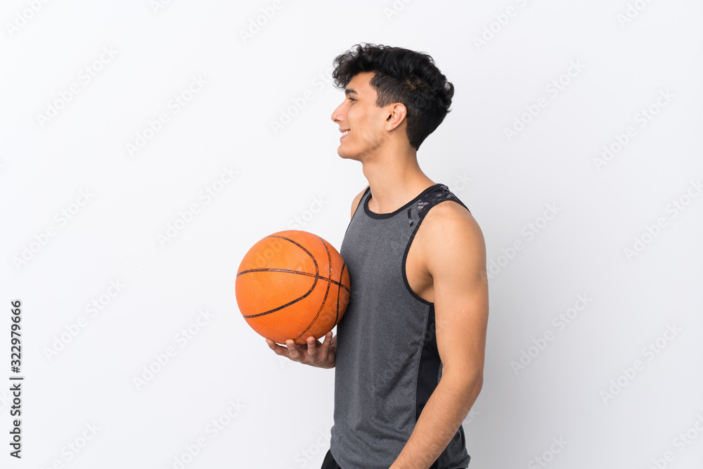 Basketball player man over isolated white background looking side Basketball player man over isolated white background looking side