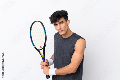 Young Argentinian man over isolated white background playing tennis © luismolinero