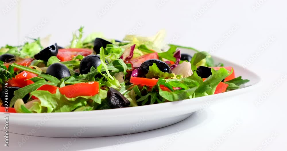 Freshness salad prepared with green spinach, tomatoes and black olives. Healthy food and vegetarian concept. Fresh lunch, closeup, macro Freshness salad prepared with green spinach, tomatoes and black olives. Healthy food and vegetarian concept. Fresh lunch, closeup, macro