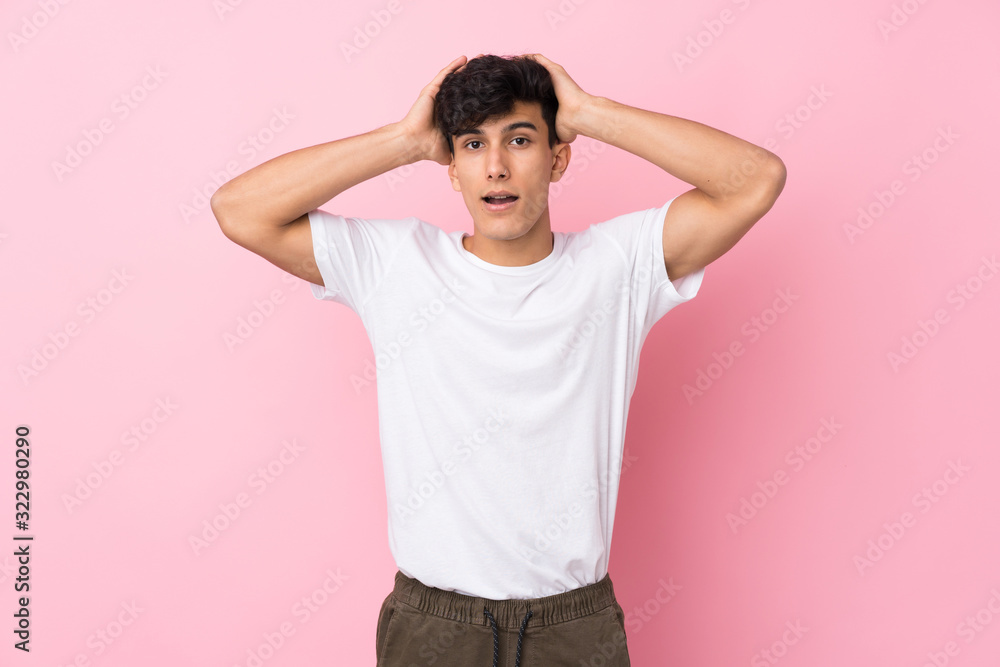 Young Argentinian man over isolated pink background with surprise facial expression Young Argentinian man over isolated pink background with surprise facial expression