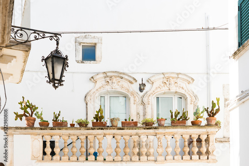Photography white house with balcony and cactus plants in Martina Franca, Italy