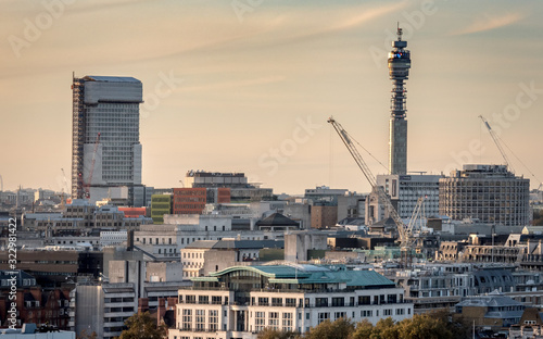 London skyline at dusk. A view of the city skyline dominated by the BT Tower and Centre Point building under renovation. photo
