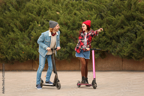 Young couple with kick scoo...