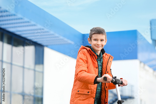 Teenage boy riding kick sco...