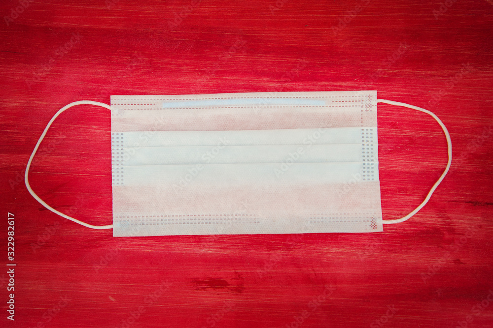 white medical mask on a red background white medical mask on a red background
