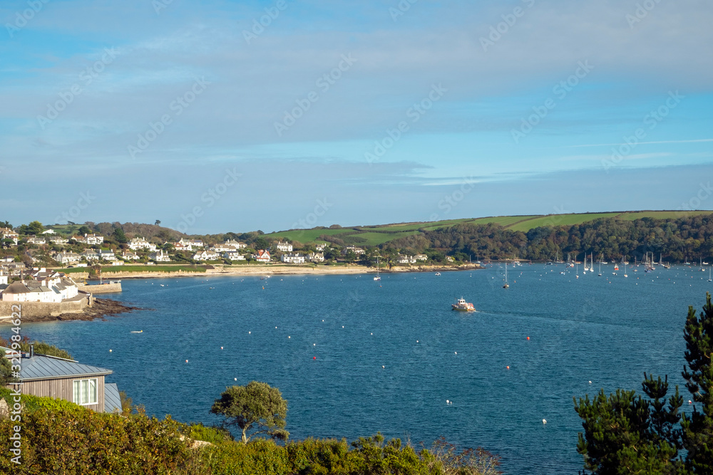 Looking back across blue sea towards St Mawes town, Cornwall, England, UK