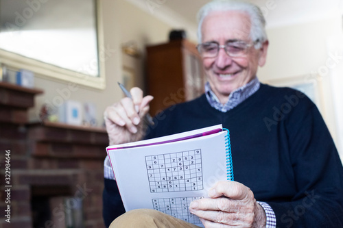 Tableau sur toile Senior Man Doing Sudoku Puzzle At Home