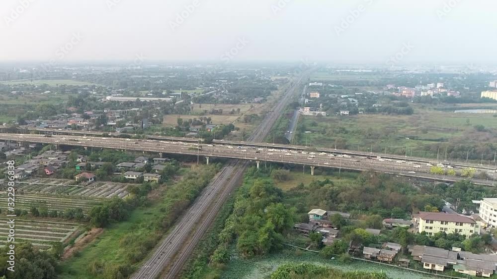 Aerial dolly in over bridge crossing railway track in Thailand Aerial dolly in over bridge crossing railway track in Thailand