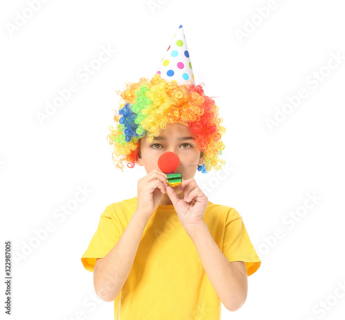 Little boy in funny disguise and with party whistle on white background. April fools  day celebration