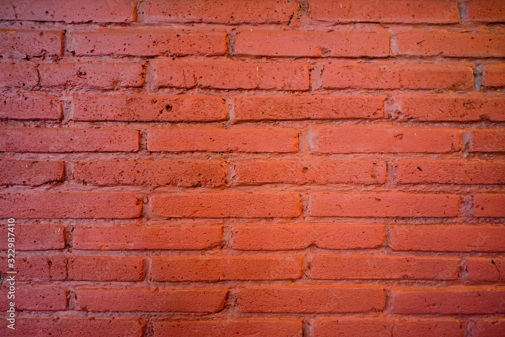 Obraz premium Brick wall orange background with lighting and shadow