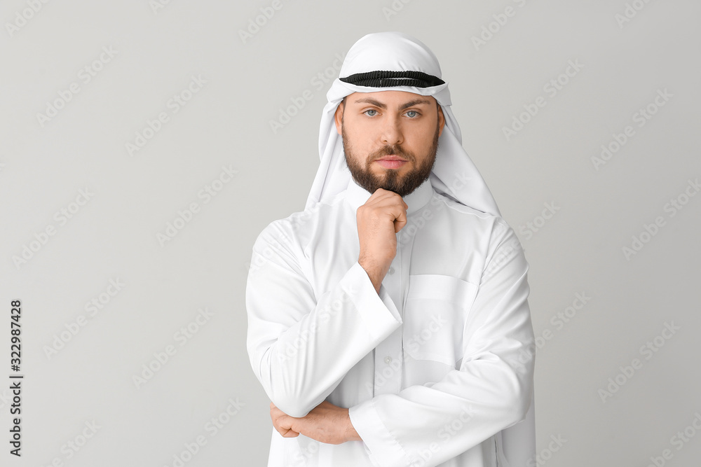 Handsome Arab man on grey background Handsome Arab man on grey background