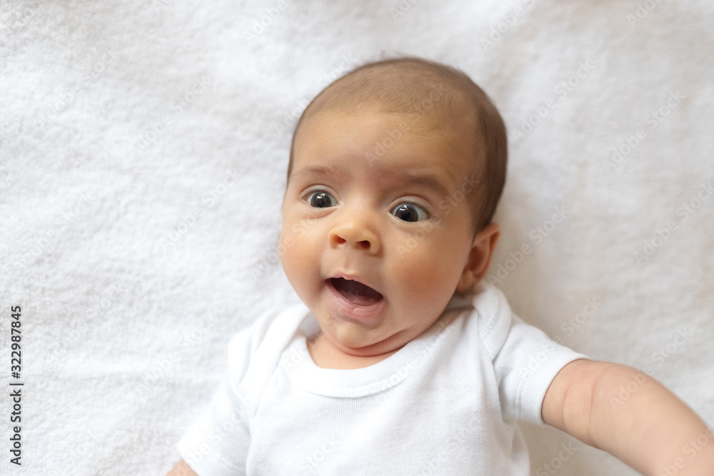 Newborn baby. A little boy in white clothes. Beautiful portrait of a toddler. Big-eyed baby. Newborn baby. A little boy in white clothes. Beautiful portrait of a toddler. Big-eyed baby.