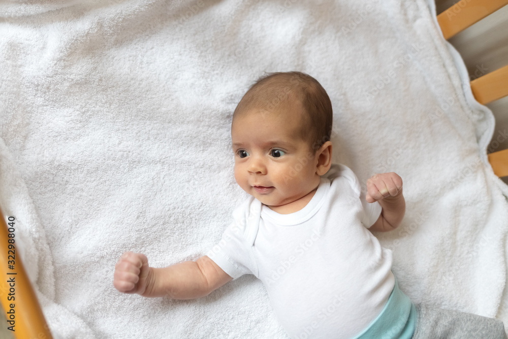 Newborn baby. A little boy in white clothes. Beautiful portrait of a toddler. Big-eyed baby. Newborn baby. A little boy in white clothes. Beautiful portrait of a toddler. Big-eyed baby.
