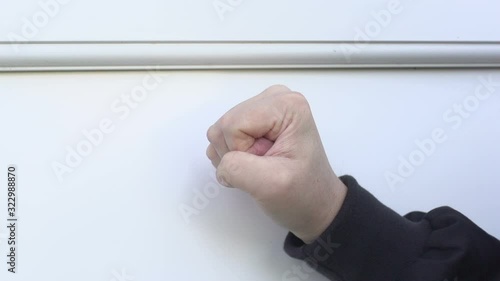 Thug / Hard man banging or knocking on the door with his fist - Slow Motion