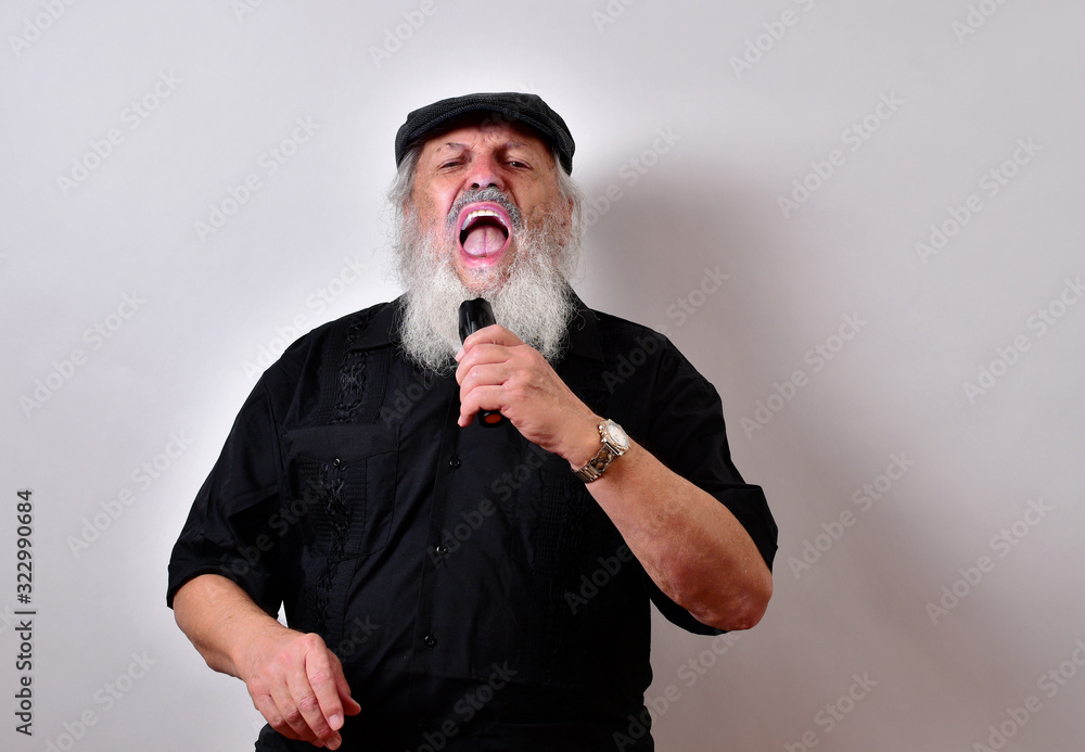 Old man singing in a karaoke bar..Party animal belting out a song.Senior man singing with passion Old man singing in a karaoke bar..Party animal belting out a song.Senior man singing with passion