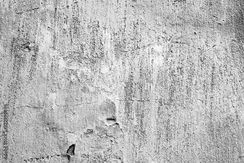 Fototapeta premium Texture of a concrete wall with cracks and scratches which can be used as a background