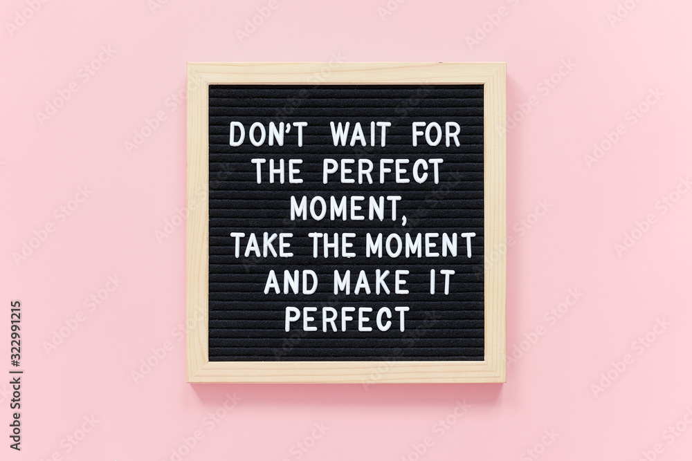 Fototapeta Don't wait for the perfect moment, take the moment and make it perfect. Motivational quote on black letter board frame on pink background. Concept inspirational quote of the day.