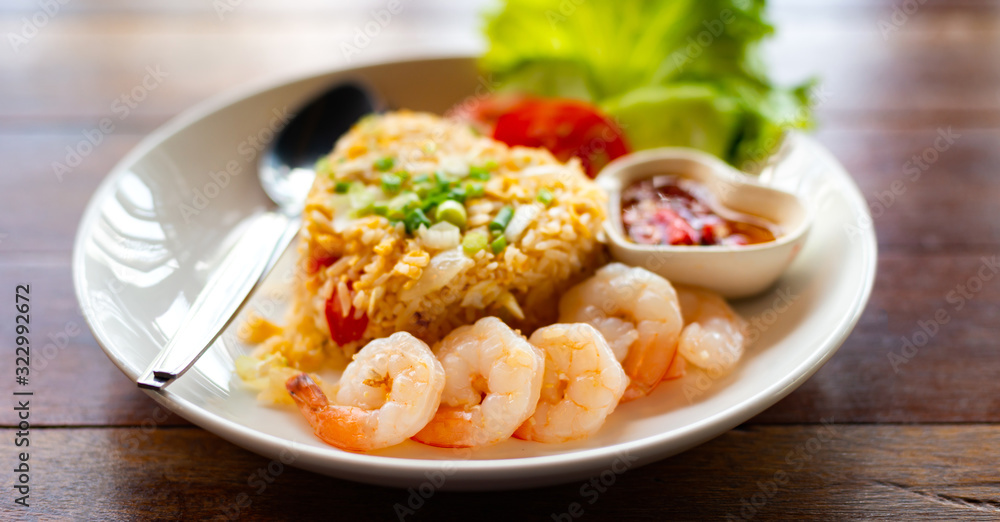 Close up spicy shrimp with Fried rice on wooden table , Home made food Thai style.Photo select focus. Close up spicy shrimp with Fried rice on wooden table , Home made food Thai style.Photo select focus.
