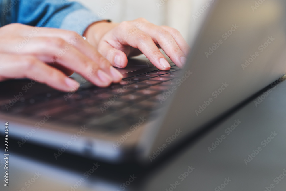 Closeup image of a woman working and typing on laptop computer on the table Closeup image of a woman working and typing on laptop computer on the table