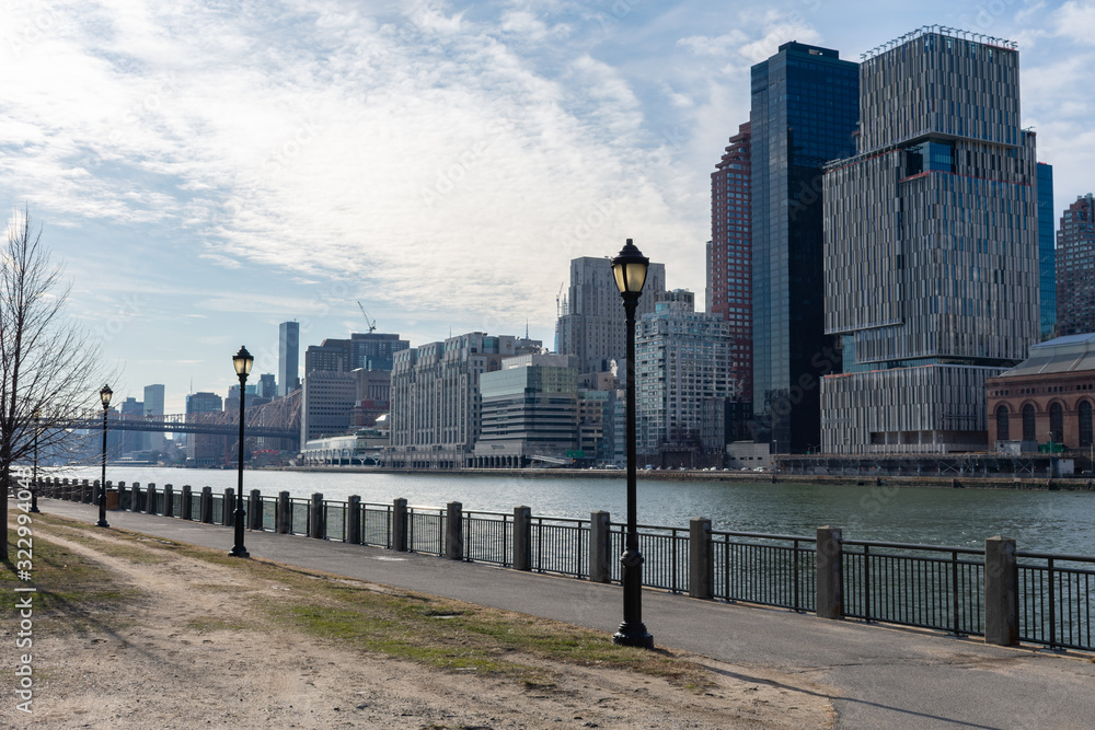Waterfront along the East River at Roosevelt Island and looking towards the Upper East Side Skyline of New York City