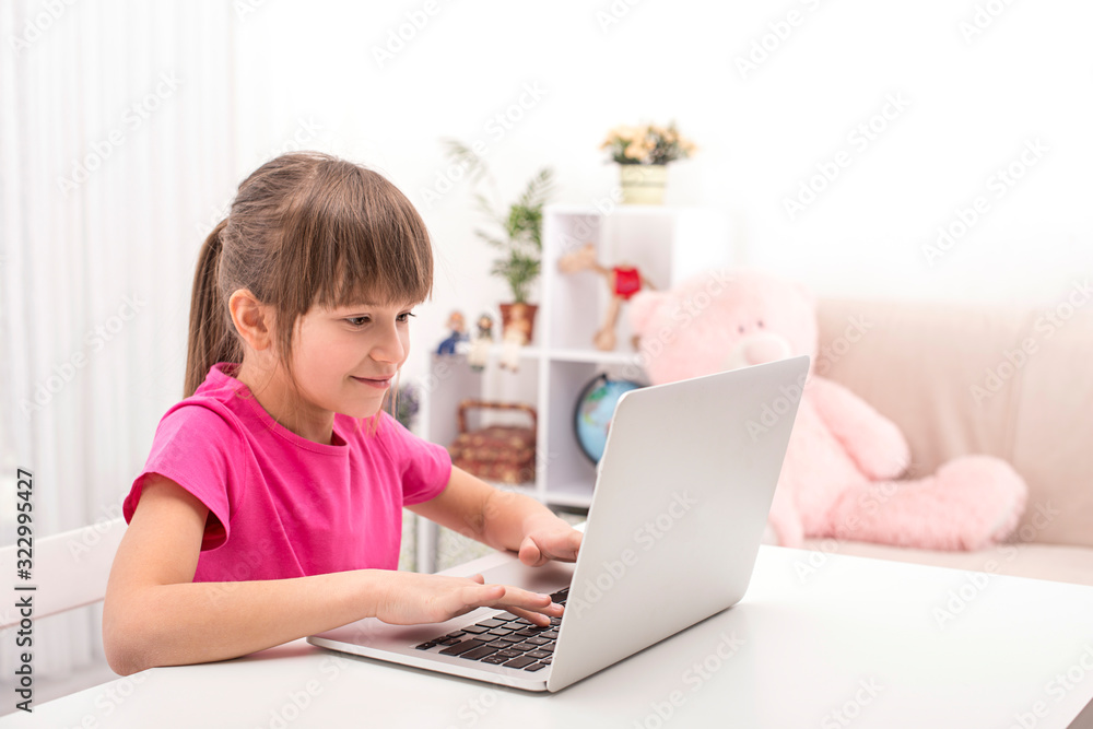 Shot of schoolgirl using a laptop  to complete school tasks