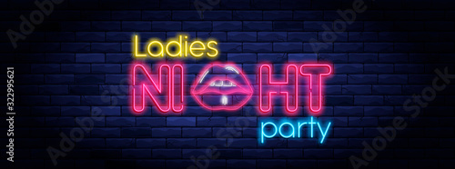 Ladies night party neon banner. Brightly illuminated neon sign of sexy woman lips. Neon lettering on brick wall background. Disco club event flyer template. Nightlife and entertainment signboard.
