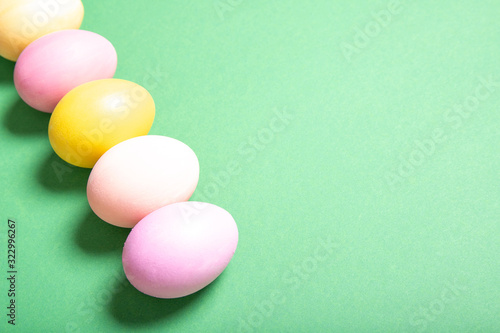 easter eggs on green background, place for text, top view, isolation
