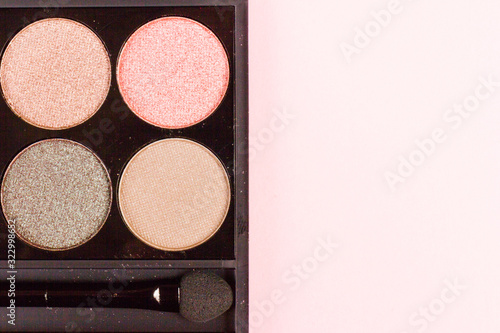 Photography set of pastel eyeshadows isolated on rose background