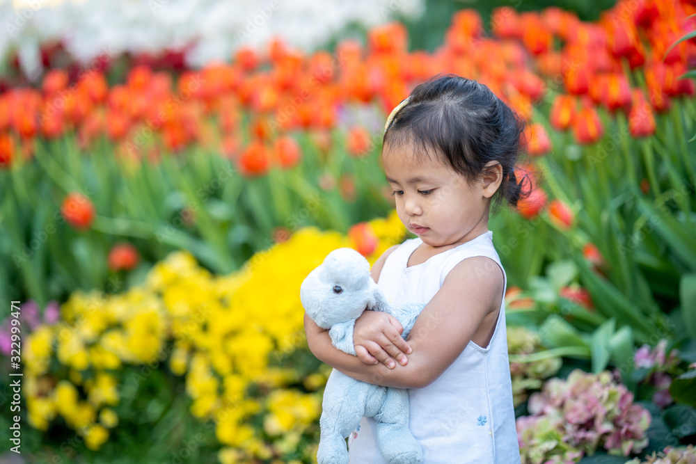 Cute little girl sitting at flower garden in Thailand. Cute little girl sitting at flower garden in Thailand.