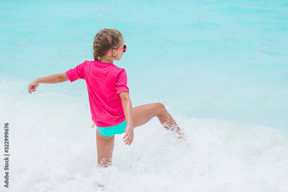 Cute little girl at beach during caribbean vacation