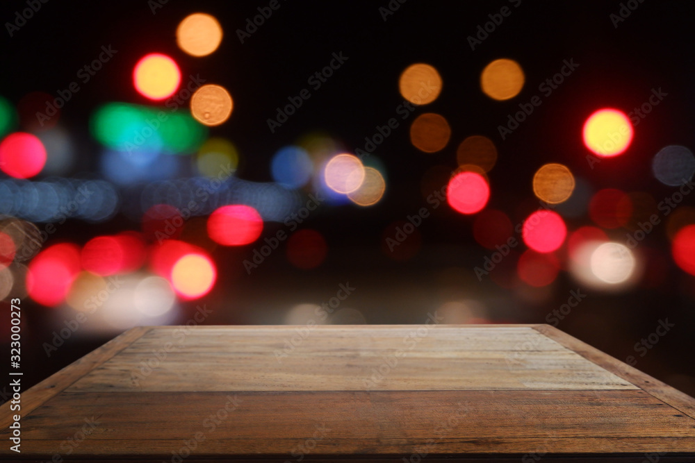 Empty wooden table in front of abstract blurred bokeh light of Cafe, restaurant at night Empty wooden table in front of abstract blurred bokeh light of Cafe, restaurant at night