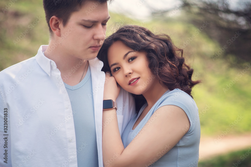 Young couple in love outdoor.Couple posing in summer in field.Smiling couple in love outdoors