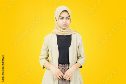 Portrait of Asian women with sad face on yellow background