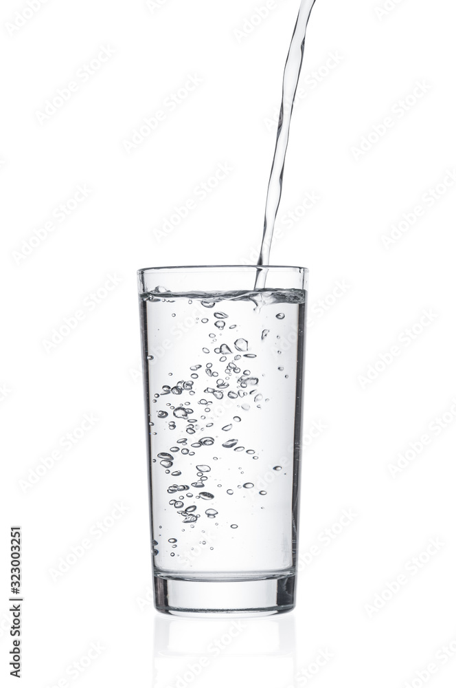 Flowing pure water into tumbler on white background Flowing pure water into tumbler on white background