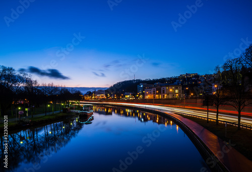 Germany, Saarbruecken city highway traffic and silent water of saar river from night to day sunrise morning