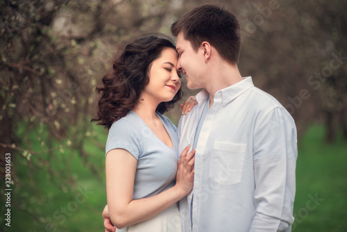 Young couple in love outdoor.Couple posing in summer in field.Smiling couple in love outdoors
