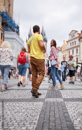 beautiful young couple having a walk on streeta of prague. Tourism, people, sights photo