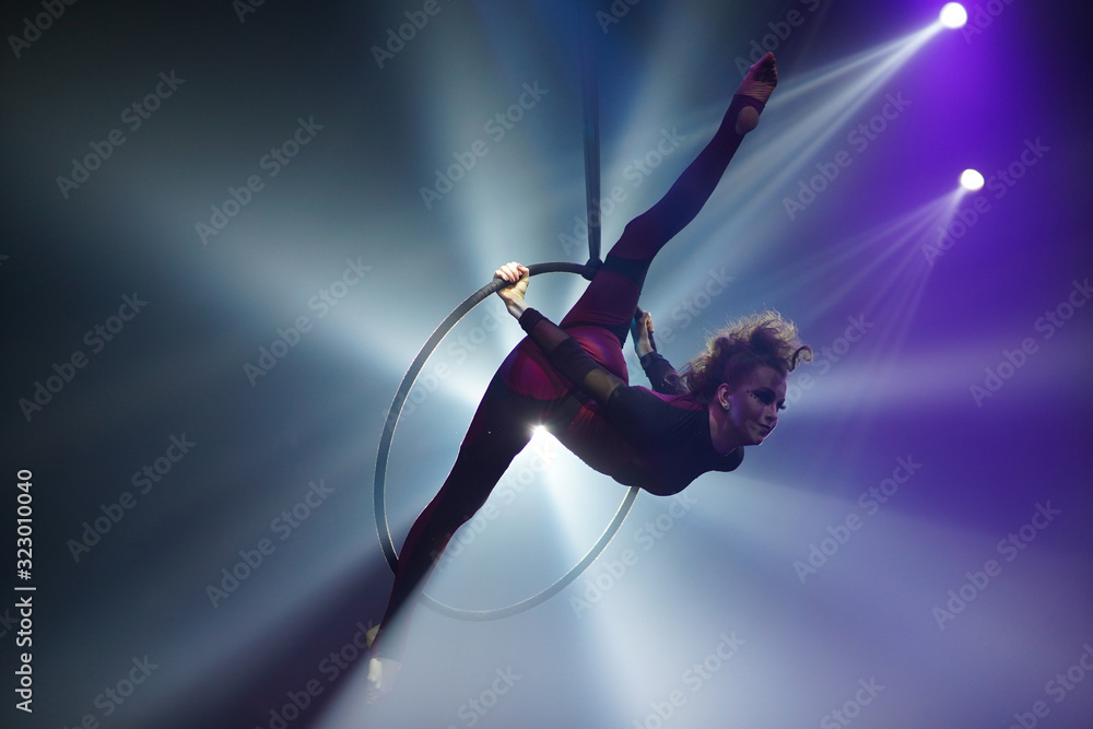Flexible young woman make performance on aerial hoop, flexiable