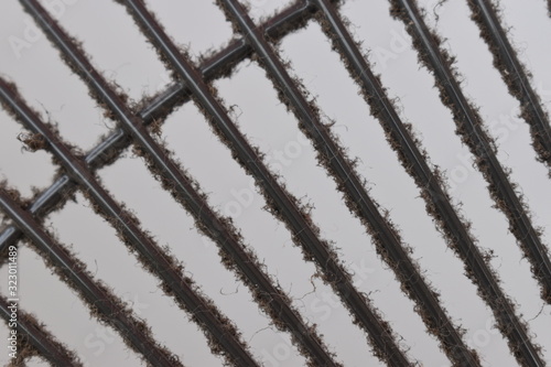 Close-up the dirty grill of electric fan, air pollution and health care concept.