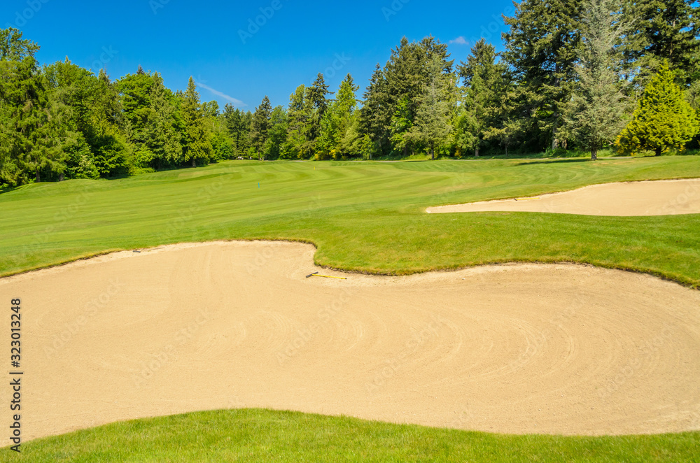 Golf course with gorgeous green and sand bunker